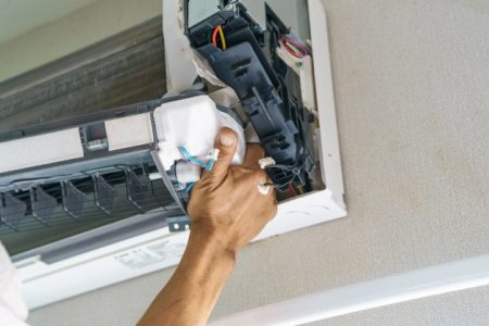 service-technician-is-cleaning-repair-maintenance-air-conditioner | handyman in dubai | Hnadyman services in dubai